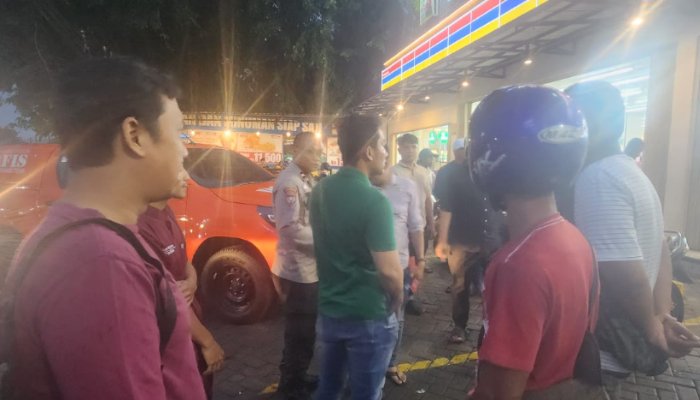 Pegawai toko waralaba sedang menunjukkan posisi korban yang ditemukan meninggal di depan took, kepada polisi, Selasa 12 Agustus 2025. (dok. Humas Polres Serang)