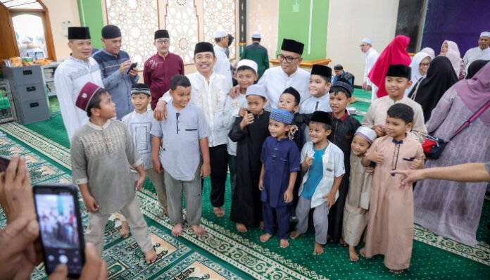Gubernur Banten Andra Soni berfoto bersama anak-anak usai menghadiri peringatan Maulid Nabi Muhammad SAW di Masjid Baiturrahman, Paninggilan, Kota Tangerang, Minggu, 21 September 2025.