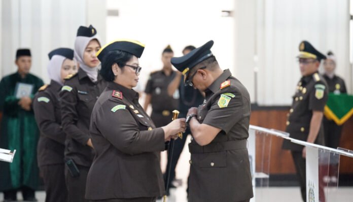 Kajati Banten Kepala Kejaksaan Tinggi Banten, Bernadeta Maria Erna Elastiyani, menyematkan tanda jabatan kepada Wakajati Banten pada upacara pelantikan eselon II dan III di Aula Utama Kejati Banten, Rabu (29/10/2025).
