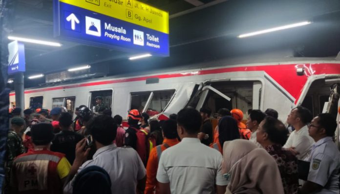 Petugas mengevakuasi korban tabrakan KA dan KRL di Stasiun Bekasi Timur untuk dibawa ke rumah sakit