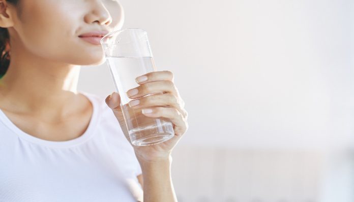 Ilustrasi wanita sedang minum air putih (Foto: Freepik)